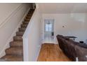 Bright foyer featuring hardwood floors, a staircase, and views into other rooms at 1942 Grove Way, Hampton, GA 30228