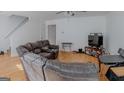 Inviting living room with wood flooring, a fan, and comfortable seating at 1942 Grove Way, Hampton, GA 30228