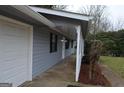 Covered front porch is accessible from the attached 2 car garage at 4142 Campbell Rd, Snellville, GA 30039