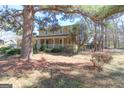Charming two-story home with a classic porch, surrounded by lush trees and beautiful landscaping at 401 Waterwood Bnd, Peachtree City, GA 30269
