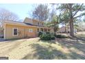 Inviting two-story residence with a quaint porch, complemented by verdant greenery and a neatly trimmed lawn at 401 Waterwood Bnd, Peachtree City, GA 30269