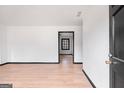 Bright entryway with light wood floors, black trim and freshly painted white walls at 1463 Rockmoor Ct, Stone Mountain, GA 30088