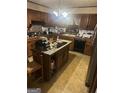 Kitchen with wooden cabinets, an island, and black appliances at 5970 Avenue Of Redwoods, South Fulton, GA 30349