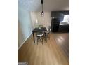 Dining area features a contemporary black table set and flows into the kitchen at 2066 Tidwell Trl, Stone Mountain, GA 30088