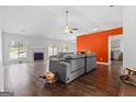 Open-concept living room with hardwood floors, a fireplace, and a view of the backyard at 121 Colemans Bluff Dr, Woodstock, GA 30188