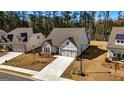 Lovely traditional home with a large driveway and attached garage, with a well-manicured lawn and landscaping at 82 Airmont Dr, Sharpsburg, GA 30277