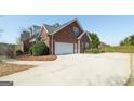 Long driveway leading to a two-car garage with ample parking space at 408 Tomahawk Trl, Mcdonough, GA 30252