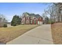Expansive brick home with a three car garage, long drive and manicured lawn at 1133 Astoria Ln, Peachtree City, GA 30269
