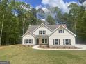 Charming two-story home with white siding, dark shutters, and manicured front lawn at 240 Jay Trl, Fayetteville, GA 30215