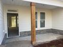 Inviting front porch, featuring a sturdy wooden pillar, stone accents and modern windows at 240 Jay Trl, Fayetteville, GA 30215