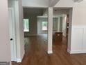 Open-concept living space featuring hardwood floors and abundant natural light from large windows at 240 Jay Trl, Fayetteville, GA 30215