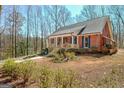 Charming brick home featuring a covered front porch and a well-manicured front yard at 150 Gill Ln, Stockbridge, GA 30281