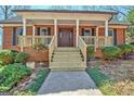 Welcoming front entrance showcasing a newly renovated porch, wood railings, and a solid front door at 150 Gill Ln, Stockbridge, GA 30281