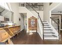 Grand entryway featuring hardwood floors, elegant staircase, and antique furniture at 2715 Ivey Crossing Trl, Cumming, GA 30041
