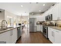 Bright kitchen featuring white cabinetry, stainless steel appliances, and granite countertops at 2715 Ivey Crossing Trl, Cumming, GA 30041