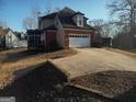 Rear of home with attached garage, screened in porch and driveway at 5700 Thrasher Sw Ln, Conyers, GA 30094