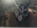 Aerial view of rear of the home with attached garage and screened in porch at 5700 Thrasher Sw Ln, Conyers, GA 30094