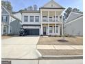 Charming two-story home with a front porch, a two-car garage, and a well-maintained lawn at 446 Bandon Way, Peachtree City, GA 30269