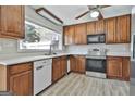 Bright kitchen featuring wooden cabinets, stainless steel appliances, and a large window overlooking the backyard at 401 Pinegate Rd, Peachtree City, GA 30269