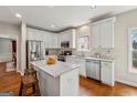 Bright kitchen with white cabinetry, stainless steel appliances, and a granite-topped island at 211 Mill Grove Sw Way, Smyrna, GA 30082