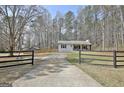 Long private driveway leads to a well-maintained home surrounded by mature trees and lush greenery at 1120 Minix Rd, Sharpsburg, GA 30277