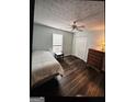Well-lit bedroom featuring luxury vinyl floors and a ceiling fan at 332 Black Willow Ct, Locust Grove, GA 30248