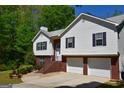 Two story home with two car garage and brick entryway at 332 Black Willow Ct, Locust Grove, GA 30248