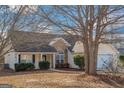 Inviting single-story home featuring stone accents, a well-manicured lawn, and a welcoming front entrance at 75 Heatherstone Way, Covington, GA 30016