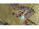 Aerial view of an estate featuring a pool, tennis court, and brick home on an expansive lot at 2940 E Lake Rd, Mcdonough, GA 30252