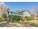 Lovely home with blue siding, brick accents, well-maintained landscaping, and a cozy, inviting entrance at 3006 Deshong Dr, Stone Mountain, GA 30087
