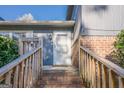 Inviting entryway featuring brick steps, wooden railings, and a bright white front door at 3006 Deshong Dr, Stone Mountain, GA 30087