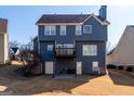 View of the backyard with a small deck and walk out basement at 9989 Village South Dr, Douglasville, GA 30135