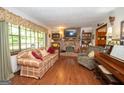 Cozy living room featuring a brick fireplace, built-in shelving, and large windows at 1972 Cox Dr, Austell, GA 30168