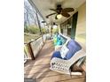 Cozy covered porch featuring wicker furniture, ceiling fans, and painted railing at 1972 Cox Dr, Austell, GA 30168