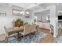 Bright dining room featuring coffered ceilings, wainscoting, and an open view to the living room at 445 Sawmill Trce, Hampton, GA 30228