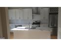 Bright kitchen featuring stainless steel appliances, mosaic tile backsplash, and stylish cabinets with granite countertops at 2085 Dellwood Pl, Decatur, GA 30032