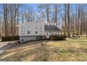 Attractive exterior elevation of a home featuring well-maintained landscaping and mature trees at 3747 Junior Ln, Douglasville, GA 30135