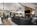 Open living room and kitchen featuring a stone fireplace, vaulted ceilings, and dining area at 3747 Junior Ln, Douglasville, GA 30135