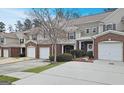 View of the townhome exteriors, showcasing their cohesive design and attached garages at 102 Ellis Dr, Conyers, GA 30012