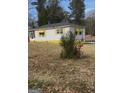 A cozy single-story house with white siding, black roof, and yellow awning accents at 3100 Bay St, Scottdale, GA 30079
