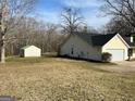 Wide backyard with plenty of room, storage shed and paved driveway at 328 Cattlemans Cir, Mcdonough, GA 30252