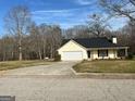 Front view of the house showing its siding, front door and paved driveway at 328 Cattlemans Cir, Mcdonough, GA 30252