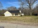 Front of the house with its siding and paved driveway at 328 Cattlemans Cir, Mcdonough, GA 30252
