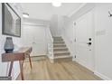 Bright foyer featuring a staircase, storage closets, and stylish decor at 117 Everhill, Peachtree City, GA 30269