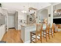 Well-lit kitchen with white cabinets, granite countertops, and an island with bar seating at 2510 Shoreline Pkwy, Villa Rica, GA 30180