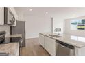Modern kitchen boasts stainless steel appliances, granite counters, and an open layout for cooking and entertaining at 982 Sutherland Ln # 30, Lawrenceville, GA 30043