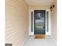 Inviting front porch with stylish door and 'Hello' welcome mat at 1067 Pinehurst Dr, Peachtree City, GA 30269