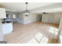 Stylish open floor plan showcases hardwood floors and neutral paint tones, connecting living spaces at 299 Lagrange St, Grantville, GA 30220