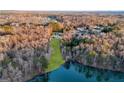 Expansive estate surrounded by woods, with a scenic lake view, perfect for privacy and tranquility at 4233 Sandstone Shores Dr, Stonecrest, GA 30038