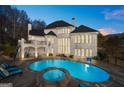 Backyard pool with jacuzzi and ample seating space for ultimate relaxation and entertaining at 4233 Sandstone Shores Dr, Stonecrest, GA 30038